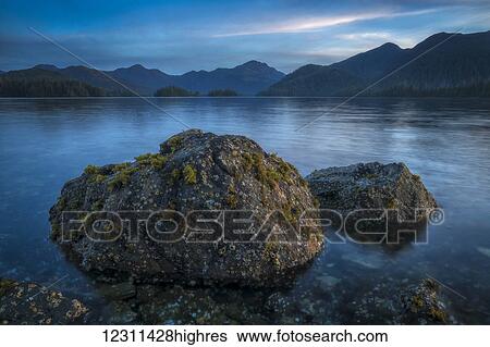 Stock Photograph - Late day light over the body of water called the Bay of Islands; Haida Gwaii, British Columbia, Canada. Fotosearch