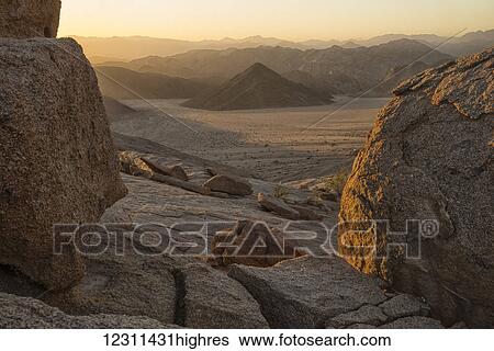 Stock Photograph - Late daylight illuminates the landscape in Richtersveld National Park; South Africa. Fotosearch