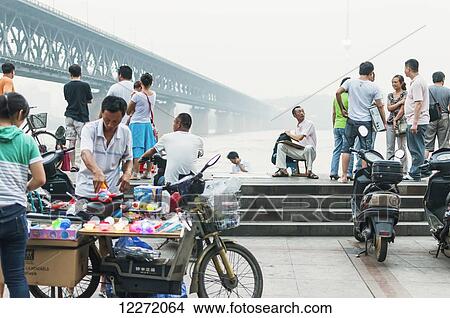 Leisure time at the Wuhan Bridge along the Yangtze River at sunset; Wuhan, Hubei province, China View Large Photo Image Picture - Leisure time at the Wuhan Bridge along the Yangtze River at sunset; Wuhan, Hubei province, China. Fotosearch