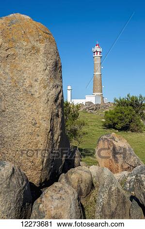 Stock Image - Lighthouse and rocks; Cabo Polonio, Uruguay. Fotosearch