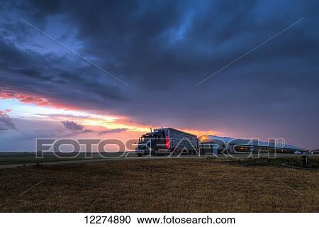Stock Image - Livestock trailer backed up to a hog confinement building at dawn, near Edgewood; Iowa, United States of America. Fotosearch