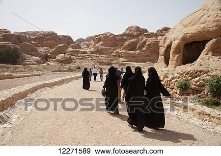 Stock Photo - Local women walking into the site; Petra, Jordan. Fotosearch