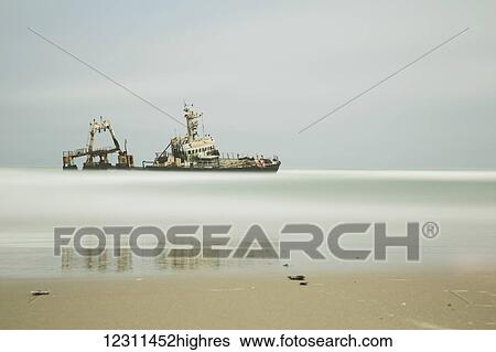 Long exposure of an unnamed shipwreck along the Skeleton Coast; Namibia View Large Photo Image Stock Photograph - Long exposure of an unnamed shipwreck along the Skeleton Coast; Namibia. Fotosearch