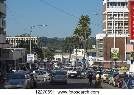 Stock Image - Looking down Victoria Avenue, the main street of Blantyre; Blantyre, Malawi. Fotosearch