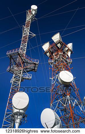 Low angle of a pair of large communication towers with wire and deep blue sky, South of Strathmore; Alberta, Canada View Large Photo Image Stock Photograph - Low angle of a pair of large communication towers with wire and deep blue sky, South of Strathmore; Alberta, Canada. Fotosearch