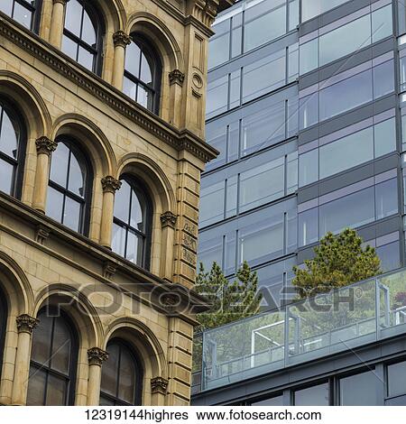 Low angle view of building facades, a contrast between old and modern; New York City, New York, United States of America View Large Photo Image Stock Photograph - Low angle view of building facades, a contrast between old and modern; New York City, New York, United States of America. Fotosearch