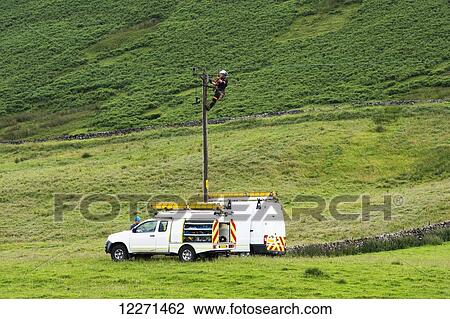 Mains electric technicians repairing a cable on a rural electricity pole; Cumbria, England View Large Photo Image Stock Image - Mains electric technicians repairing a cable on a rural electricity pole; Cumbria, England. Fotosearch