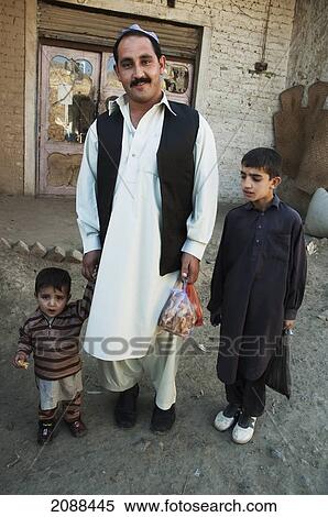 Stock Photography - Man And Boys In The Khyber Pass, Federally Administered Tribal Areas, Pakistan. Fotosearch