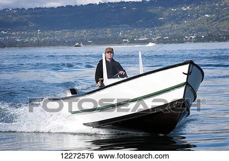 Man drives his newly-built Tolman Skiff Standard near the Homer Spit on a sunny fall day on Kachemak Bay, Southcentral Alaska View Large Photo Image Stock Photograph - Man drives his newly-built Tolman Skiff Standard near the Homer Spit on a sunny fall day on Kachemak Bay, Southcentral Alaska. Fotosearch
