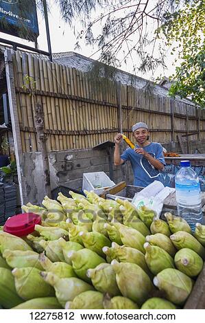 Man eating a corn on the cob, Gili Trawangan, West Nusa Tenggara, Indonesia View Large Photo Image Stock Image - Man eating a corn on the cob, Gili Trawangan, West Nusa Tenggara, Indonesia. Fotosearch