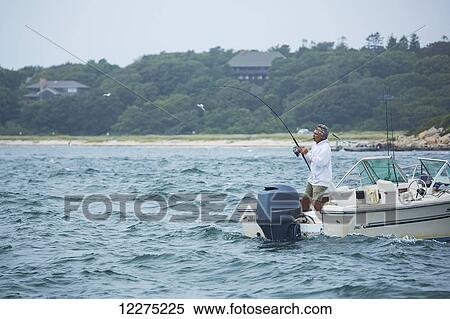 Man fishing from a boat; Cape Cod, Massachusetts, United States of America View Large Photo Image Stock Photography - Man fishing from a boat; Cape Cod, Massachusetts, United States of America. Fotosearch