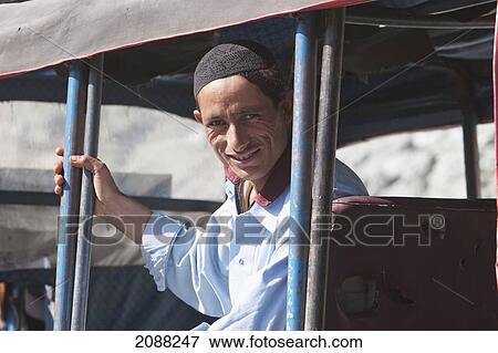 Stock Photo - Man In A Jeep, Dasu, North-West Frontier Province, Pakistan. Fotosearch
