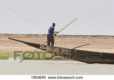 Stock Photo - Man on a boat in the Niger River between Sebi and Niafunke, Malic. Fotosearch