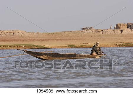 Stock Photography - Man on a boat on the Niger River between Lake Debo and Sebi, Mali. Fotosearch