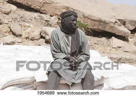 Stock Photo - Man on the banks of the Niger River in Kabara, the port of Timbuktu, Mali. Fotosearch