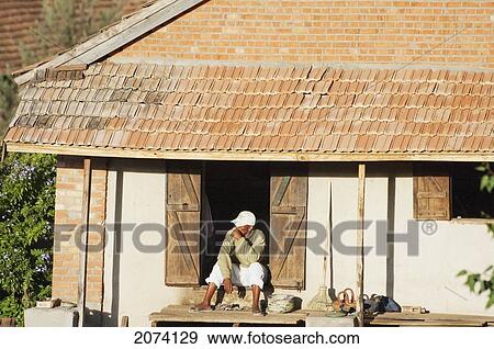 Man Sitting By His Home In Tritiva, Antananarivo Province, Madagascar View Large Photo Image Stock Photo - Man Sitting By His Home In Tritiva, Antananarivo Province, Madagascar. Fotosearch