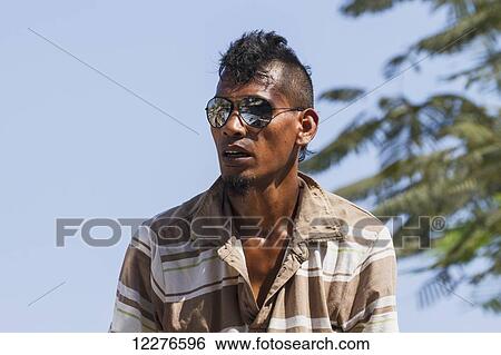 Man wearing sun glasses; Manatuto, East Timor View Large Photo Image Stock Photograph - Man wearing sun glasses; Manatuto, East Timor. Fotosearch