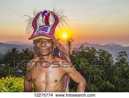 Picture - Manggarai man wearing a traditional headdress wrapped with cloth used in caci, a ritual whip fight, Melo village, Flores, East Nusa Tenggara, Indonesia. Fotosearch