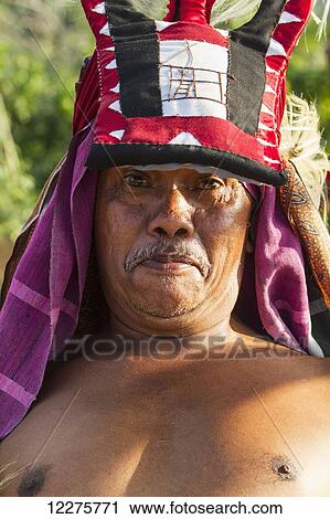 Stock Image - Manggarai man wearing a traditional headdress wrapped with cloth used in caci, a ritual whip fight, Melo village, Flores, East Nusa Tenggara, Indonesia. Fotosearch