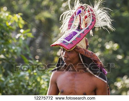 Stock Image - Manggarai man wearing a traditional headdress wrapped with cloth used in caci, a ritual whip fight, Melo village, Flores, East Nusa Tenggara, Indonesia. Fotosearch