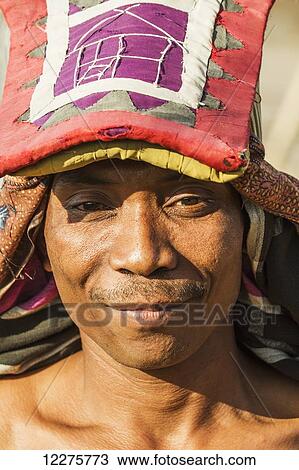Stock Image - Manggarai man wearing a traditional headdress wrapped with cloth used in caci, a ritual whip fight, Melo village, Flores, East Nusa Tenggara, Indonesia. Fotosearch