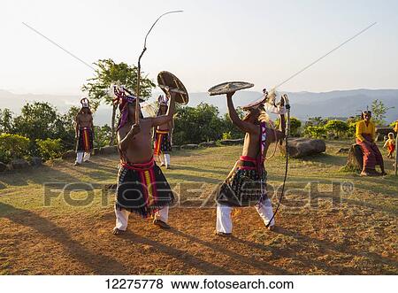 Stock Photo - Manggarai men wearing traditional headdress wrapped with cloth using shields and bamboo whips in a caci, a ritual whip fight, Melo village, Flores, East Nusa Tenggara, Indonesia. Fotosearch