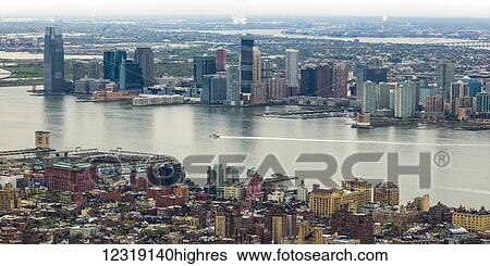 Manhattan and Brooklyn on either side of the East River; New York City, New York, United States of America View Large Photo Image Stock Photograph - Manhattan and Brooklyn on either side of the East River; New York City, New York, United States of America. Fotosearch