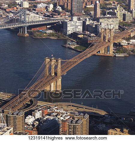Manhattan bridge and Brooklyn bridge crossing the East River; New York City, New York, United States of America View Large Photo Image Stock Photograph - Manhattan bridge and Brooklyn bridge crossing the East River; New York City, New York, United States of America. Fotosearch