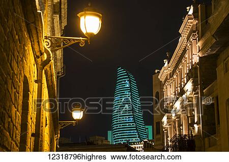 Stock Photograph - Mansions on Boyuk Qala Street with the Flame Towers in the background at night; Baku, Azerbaijan. Fotosearch