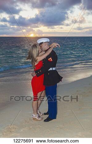 Stock Image - Marine and his lady getting engaged on the beach; Kailua, Island of Hawaii, Hawaii, United States of America. Fotosearch