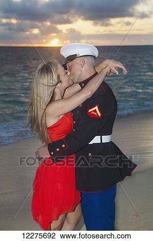 Stock Image - Marine and his lady getting engaged on the beach; Kailua, Island of Hawaii, Hawaii, United States of America. Fotosearch