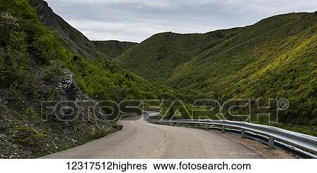 Stock Photograph - Meat Cove Road winding through the green hills; Nova Scotia, Canada. Fotosearch
