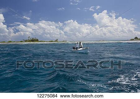 Picture - Men fishing a small atoll; Tahiti. Fotosearch
