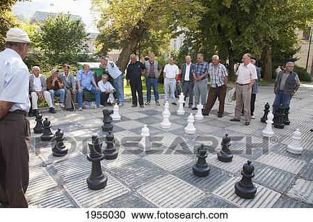 Men Playing Chess On Trg Oslobodjenja (Liberation Square), Sarajevo, Bosnia And Herzegovina View Large Photo Image Stock Image - Men Playing Chess On Trg Oslobodjenja (Liberation Square), Sarajevo, Bosnia And Herzegovina. Fotosearch