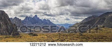 Men standing on a boulder in the distance in Tombstone Territorial Park in autumn; Yukon, Canada View Large Photo Image Stock Image - Men standing on a boulder in the distance in Tombstone Territorial Park in autumn; Yukon, Canada . Fotosearch