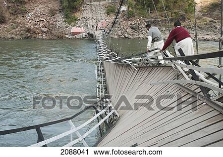 Men Walking On A Collapsed Suspension Bridge Over The Jelhum River After The 8 October 2005 Earthquake, Garhi Dopatta, Azad Jammu & Kashmir, Pakistan View Large Photo Image Stock Image - Men Walking On A Collapsed Suspension Bridge Over The Jelhum River After The 8 October 2005 Earthquake, Garhi Dopatta, Azad Jammu & Kashmir, Pakistan. Fotosearch