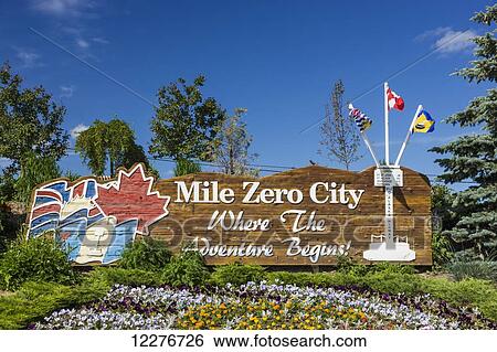 Stock Photograph - Mile Zero City Sign, the Start of Alaska Highway, Dawson Creek, British Columbia, Canada, Summer. Fotosearch