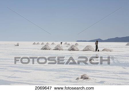 Stock Photo - Miner By Piles Of Salt At The Salar De Uyuni, The World's Largest Salt Flat, Potosi Department, Bolivia. Fotosearch
