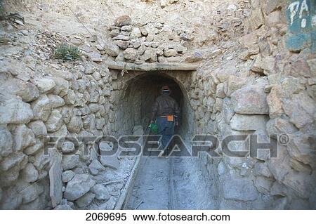 Stock Photography - Miner Entering A Shaft Of The Cerro Rico De Potos. Fotosearch