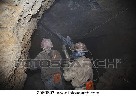 Miners Drilling Holes To Place Dynamite Into The Rock With A Compressed Air Pneumatic Drills In A Shaft Of The Cerro Rico De Potos View Large Photo Image Stock Photo - Miners Drilling Holes To Place Dynamite Into The Rock With A Compressed Air Pneumatic Drills In A Shaft Of The Cerro Rico De Potos. Fotosearch