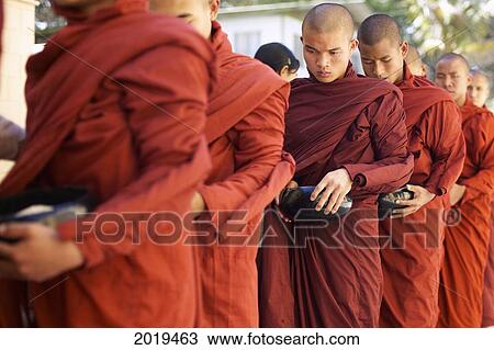 Stock Image - Monks With Rice Bowls, Inle Lake, Myanmar (Burma). Fotosearch