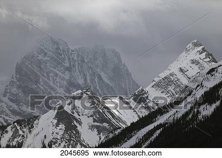 Stock Photography - Mountain Peaks In Clouds, Spray Lakes Provincial Park, Kananaskis Country Alberta Canada.. Fotosearch