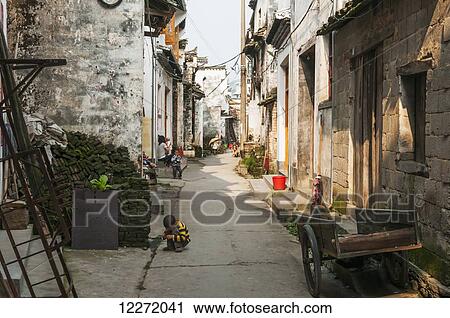 Narrow street lined with stone residences in a small village near Wuyuan; Jiangxi province, China View Large Photo Image Stock Image - Narrow street lined with stone residences in a small village near Wuyuan; Jiangxi province, China. Fotosearch
