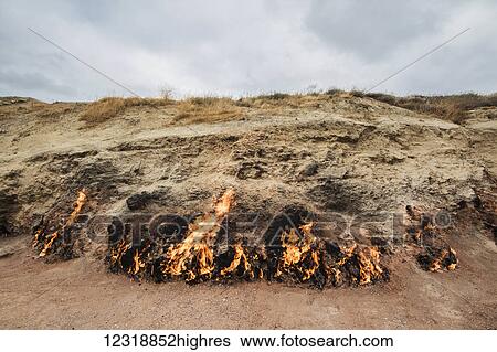 Stock Photograph - Natural gas fire which blazes continuously on a hillside, Yanar Dag, Absheron Peninsula; Baku, Azerbaijan. Fotosearch
