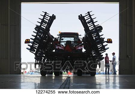Stock Photography - New 4 wheel drive tractor with folding disk ready for delivery from dealership; Nevada, Iowa, United States of America. Fotosearch