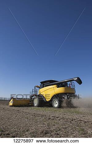Stock Photo - New Holland CR9060 Combine harvesting soybeans; Dyersville, Tennessee, United States of America. Fotosearch