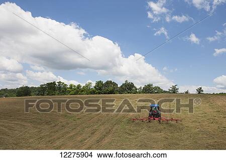 New Holland T4050 tractor with H5270 tedder in alfalfa; New Holland, Pennsylvania, United States of America View Large Photo Image Picture - New Holland T4050 tractor with H5270 tedder in alfalfa; New Holland, Pennsylvania, United States of America. Fotosearch