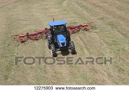 New Holland T4050 tractor with H5270 tedder in alfalfa from high angle view; New Holland, Pennsylvania, United States of America View Large Photo Image Stock Image - New Holland T4050 tractor with H5270 tedder in alfalfa from high angle view; New Holland, Pennsylvania, United States of America. Fotosearch