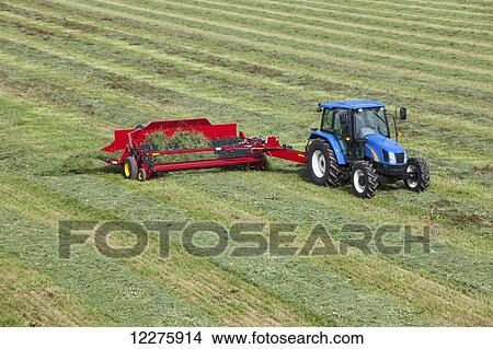 New Holland t5040 with H5430 windrow merger; New Holland, Pennsylvania, United States of America View Large Photo Image Picture - New Holland t5040 with H5430 windrow merger; New Holland, Pennsylvania, United States of America. Fotosearch