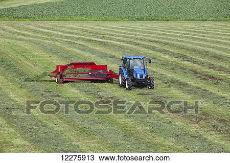 New Holland t5040 with H5430 windrow merger; New Holland, Pennsylvania, United States of America View Large Photo Image Stock Image - New Holland t5040 with H5430 windrow merger; New Holland, Pennsylvania, United States of America. Fotosearch